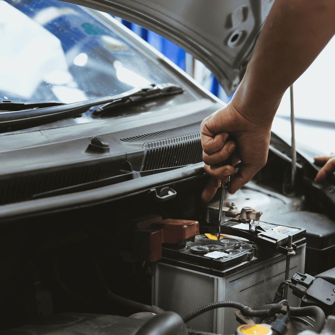 mechanic fitting a battery